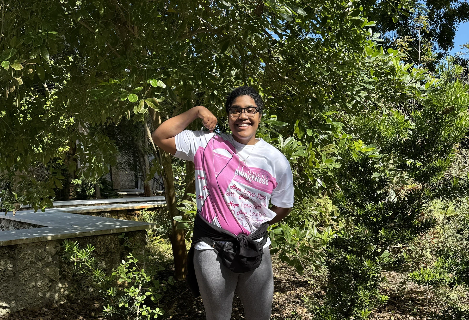 A strong LaShae Rolle flexes while exercising outside.