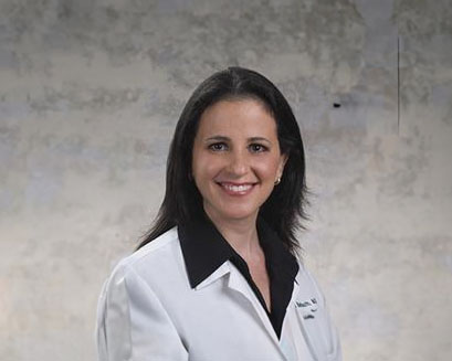 Dr. Deborah Barbouth, in white clinic coat
