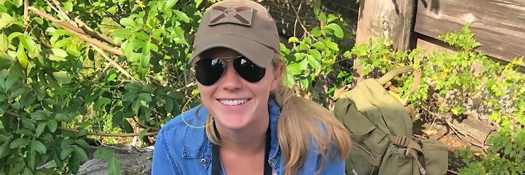 Woman in nature smiling after being successfully treated for asthma.
