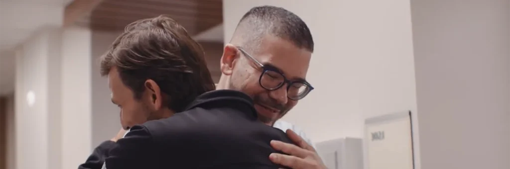 Patient hugs doctor, grateful for beating prostate cancer.