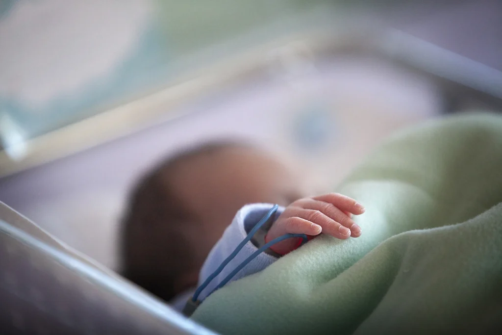 Newborn baby in the hospital. Close-up of the baby's hand