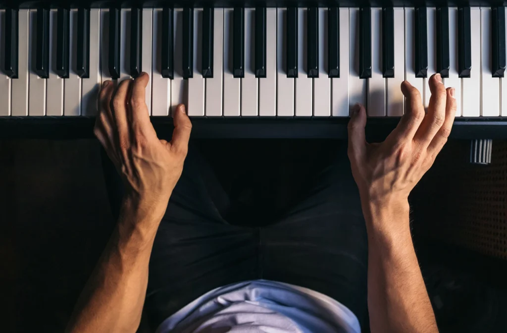 Shot of hands playing piano.
