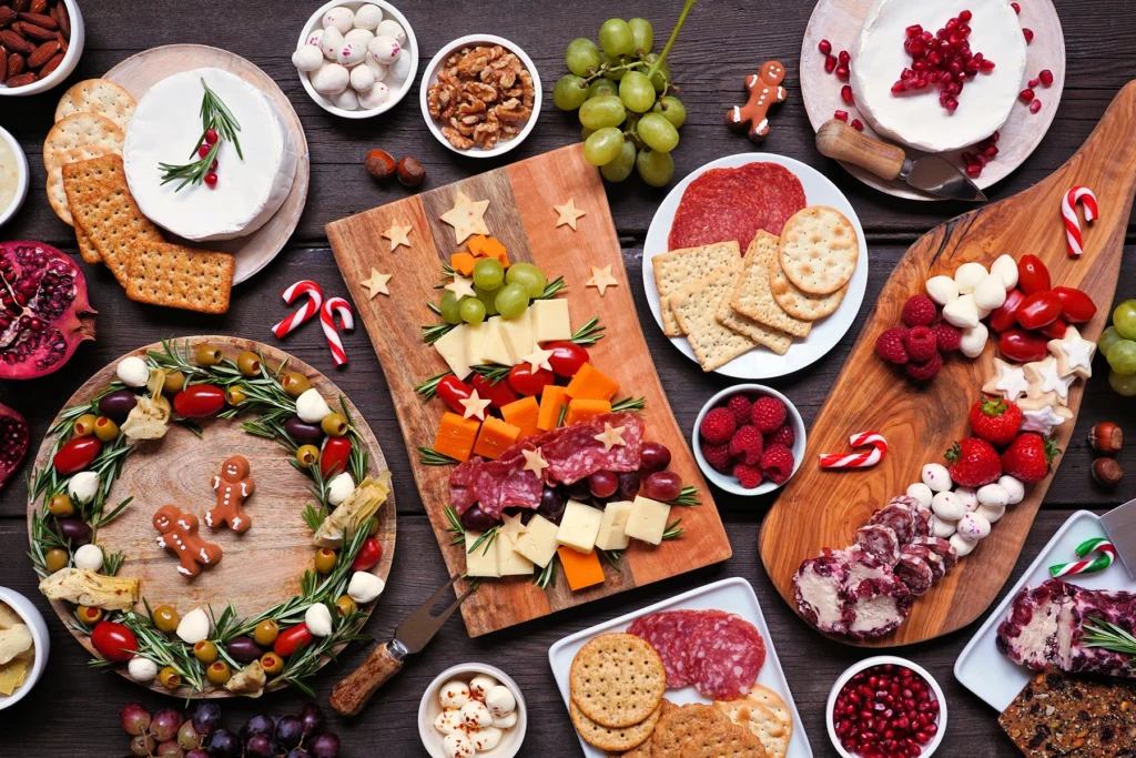 Holiday charcuterie table scene against a dark wood background - stock photo