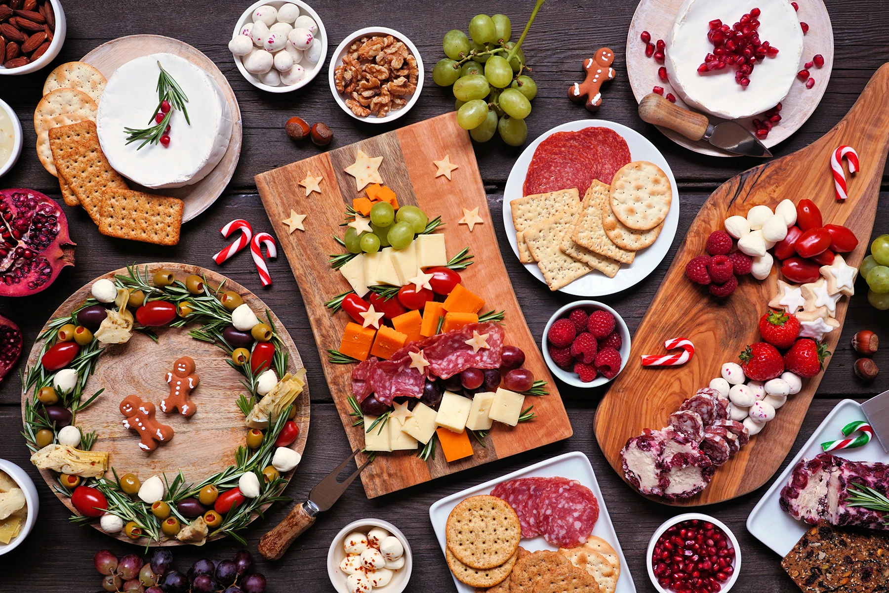 Holiday charcuterie table scene against a dark wood background - stock photo