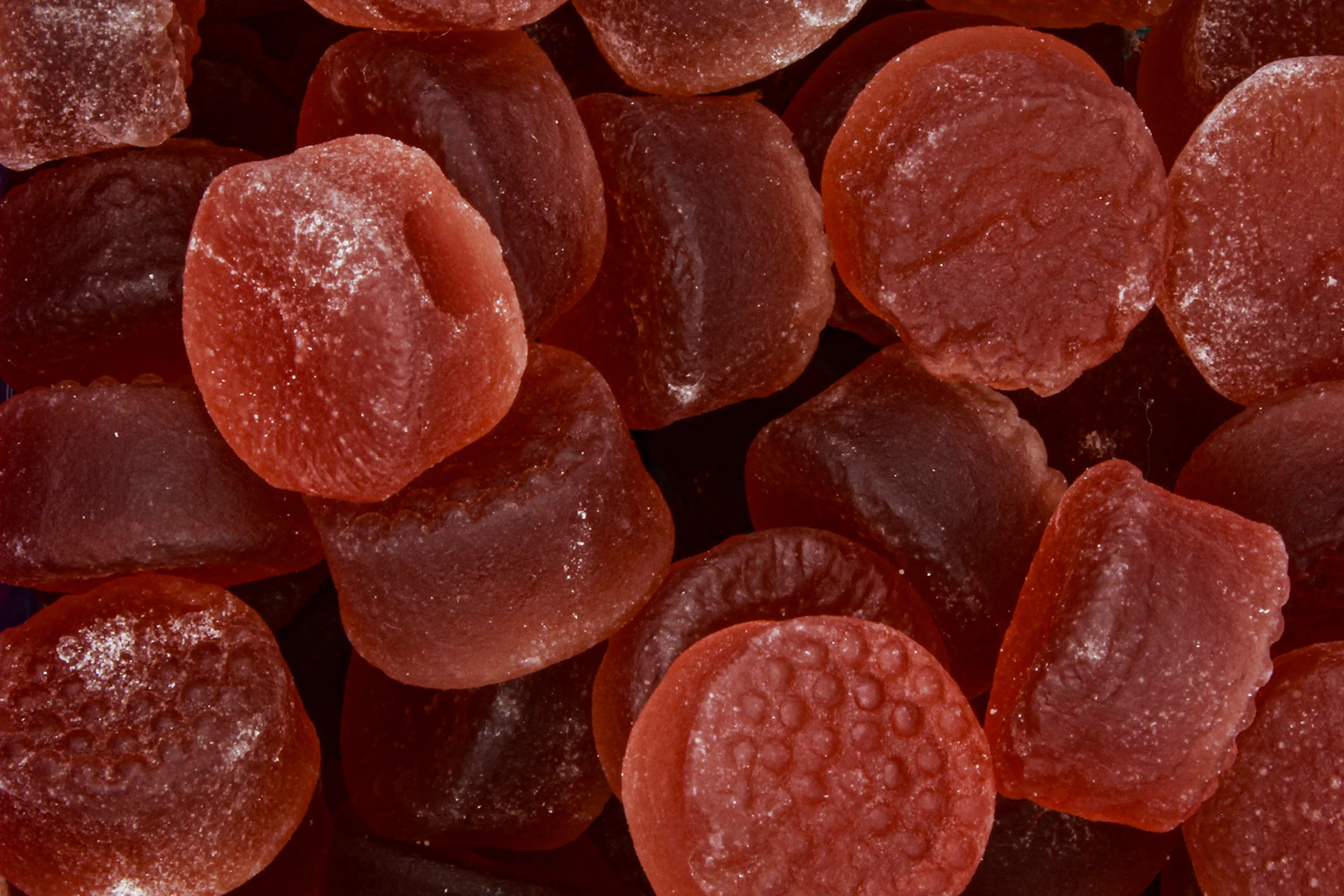 A closeup of red colored melatonin gummies