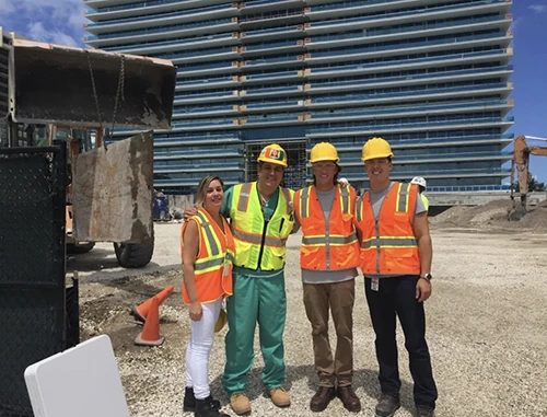 Dr. Asfar (left) with Dr. Alberto J. Caban-Martinez (second from left) and two graduate students at a Miami Beach construction site. 