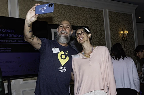 Two cancer survivors pose for a selfie.