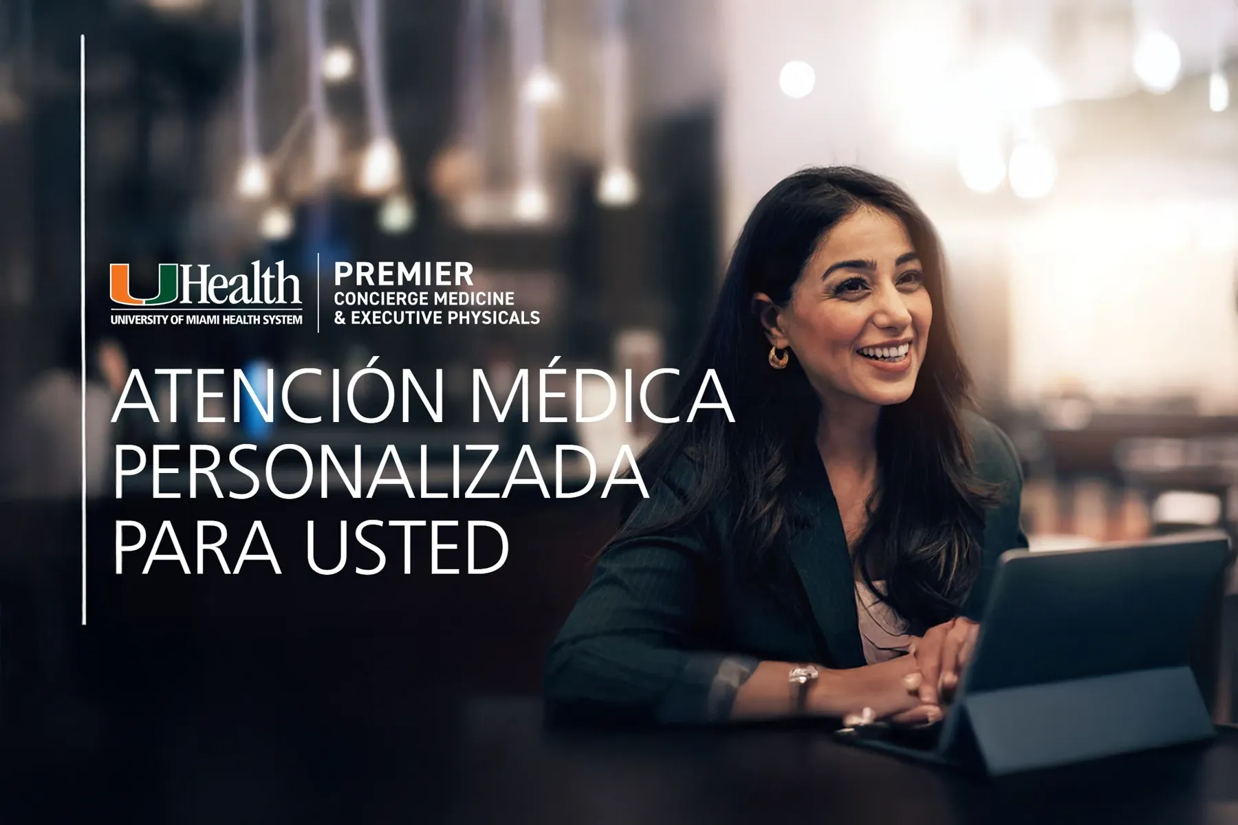 Smiling professional woman seated at a table, looking engaged with a tablet, promoting UHealth University of Miami Health System Premier Concierge Medicine and Executive Physicals, with text "Atención Médica Personalizada Para Usted" (Personalized Medical Attention for You).