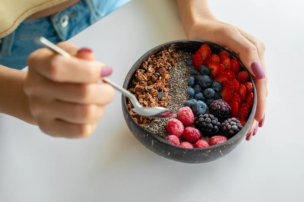 Smoothie bowl with fresh berries, chia seeds, and granola - stock photo
