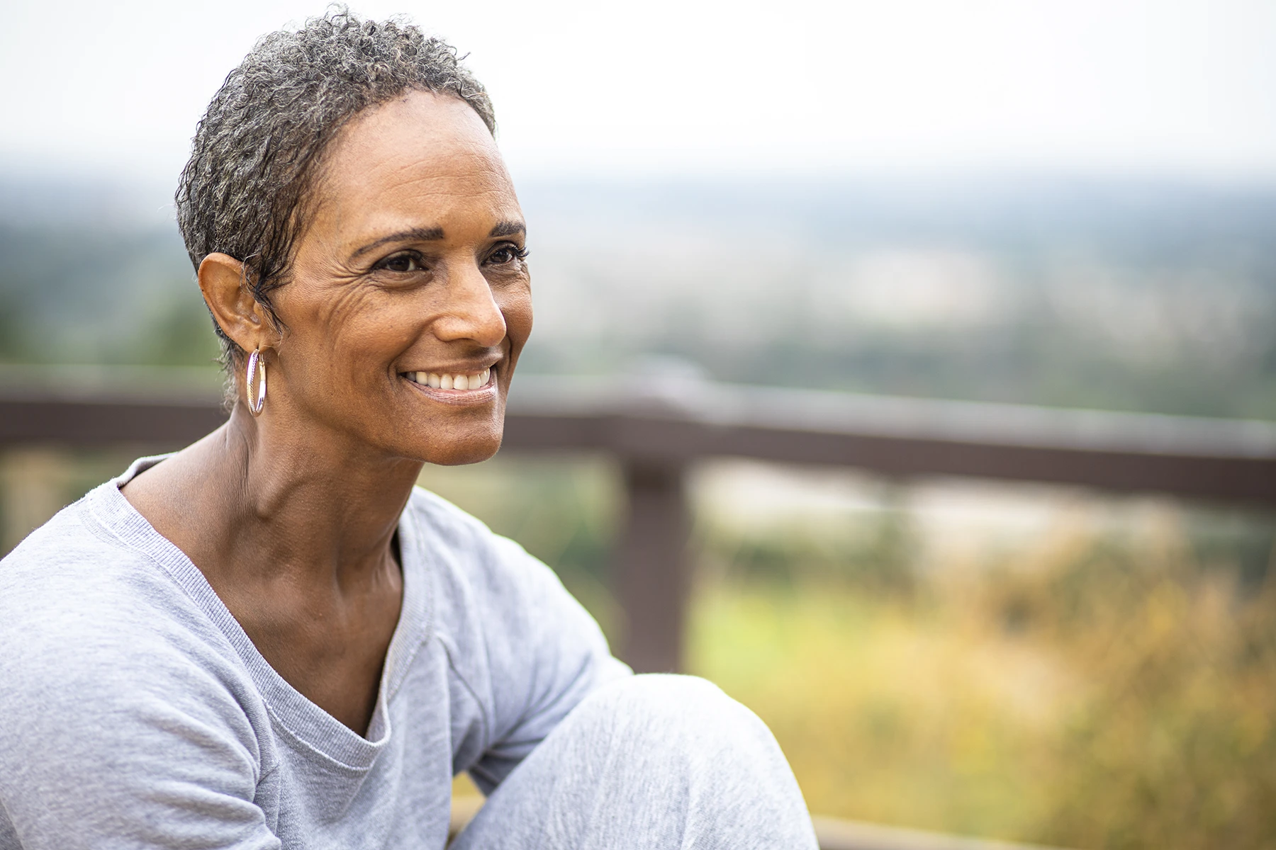 Older Black Woman feels good, smiling. Outdoor Yoga - stock photo