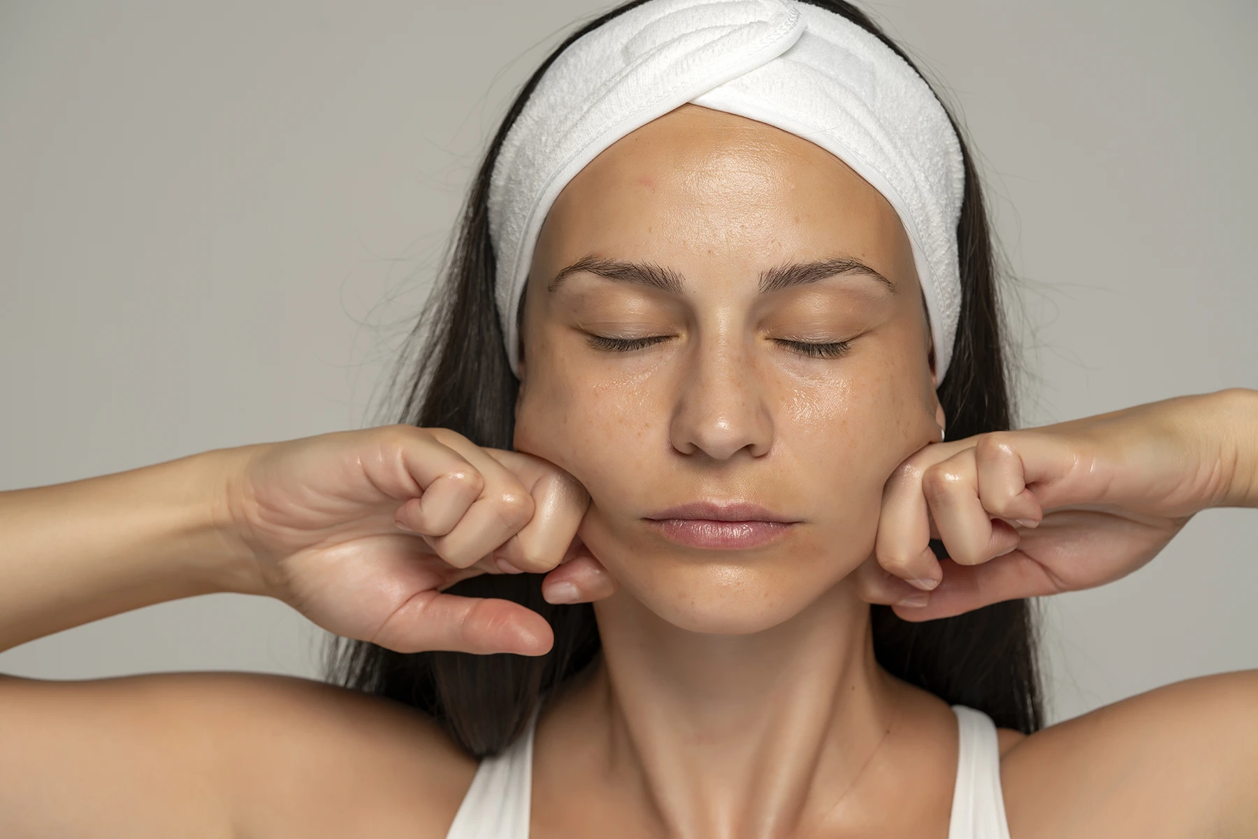 Woman massaging her face - stock photo