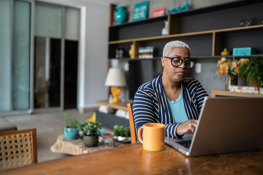 Mature Black woman working on computer. Stock image