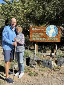 Dioron Ong poses with her husband outside the entrance to a nature park.