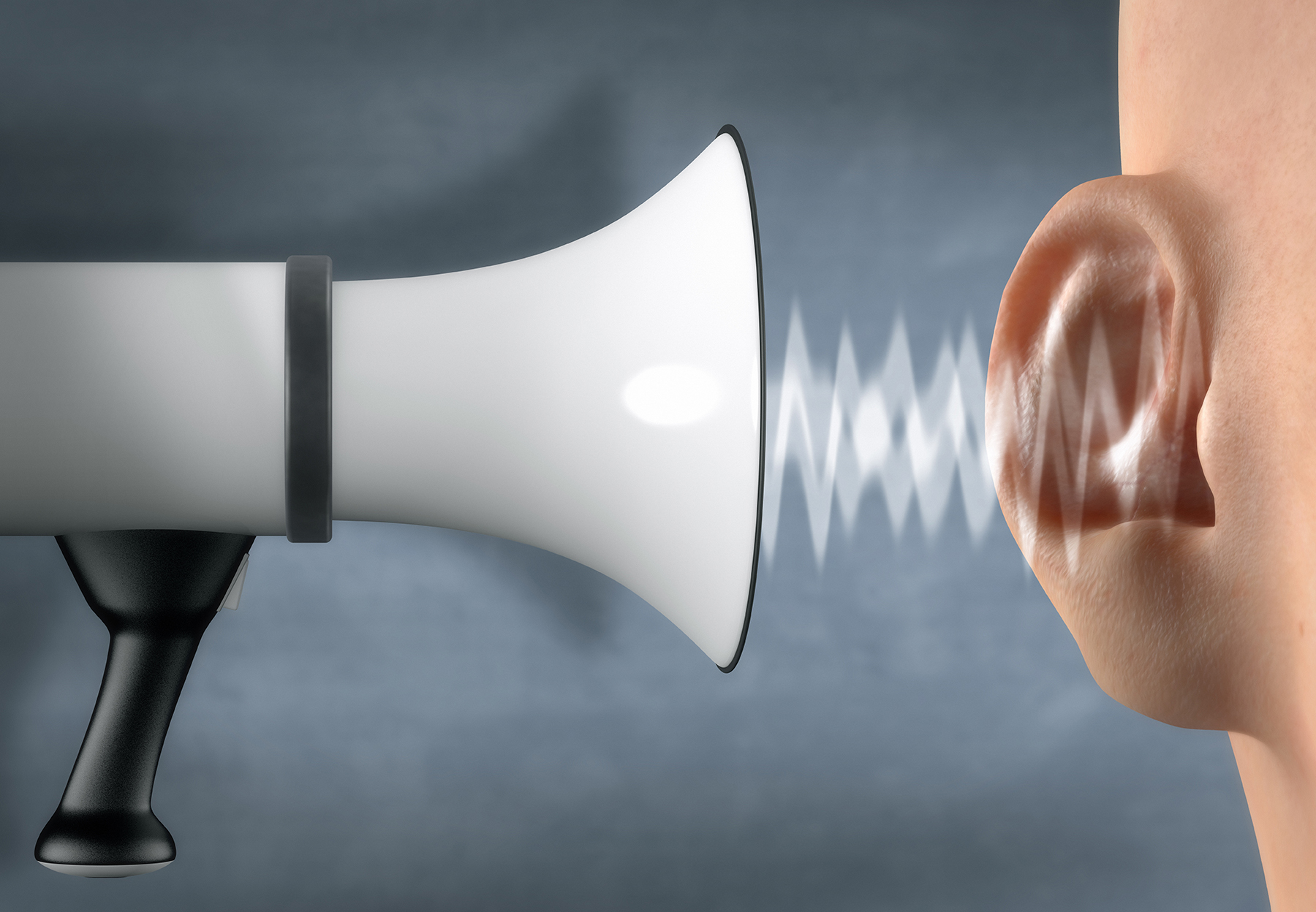 Megaphone yelling in front of an ear - stock photo