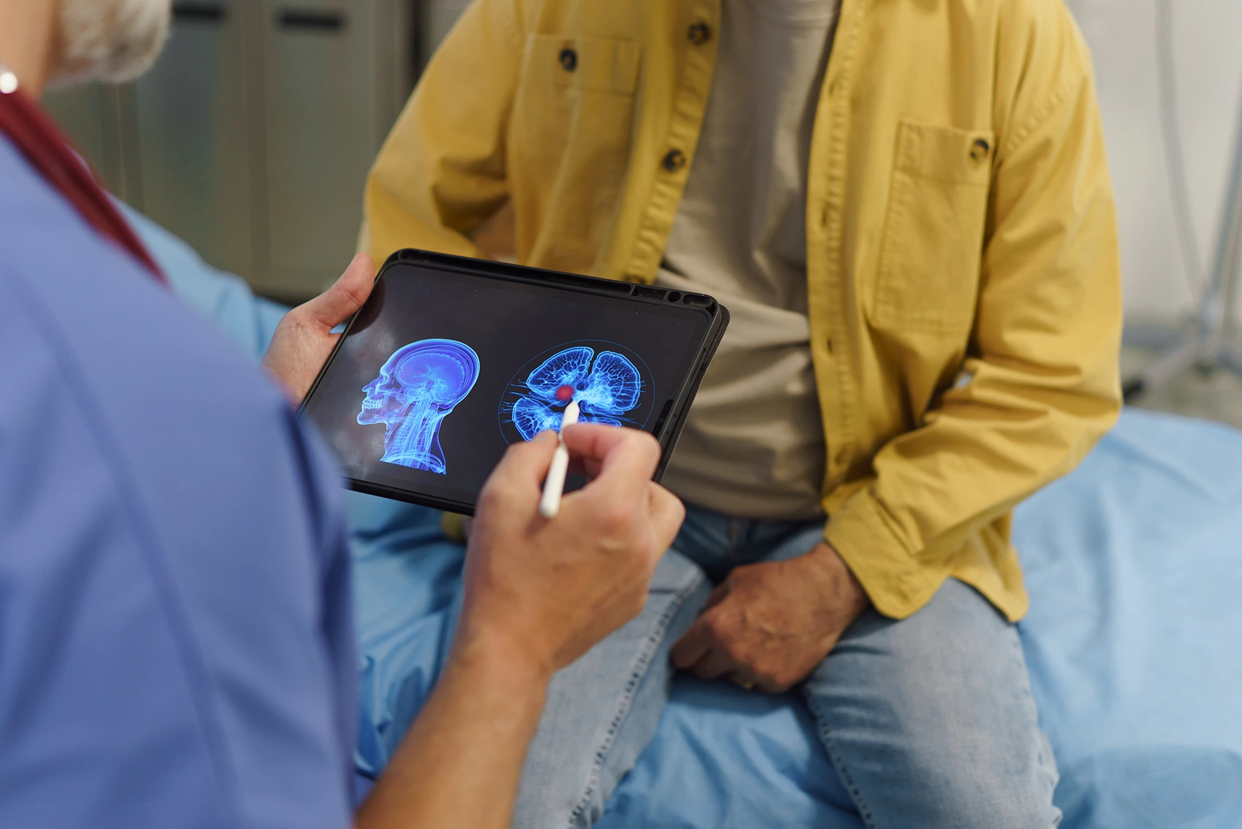 Doctor talking with senior patient, showing him medical result on tablet. - stock photo