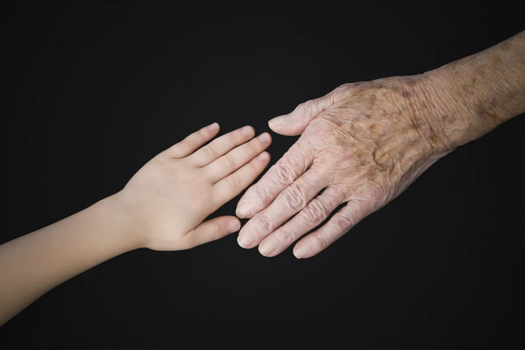 Age spots depiction – young and old hands - stock photo