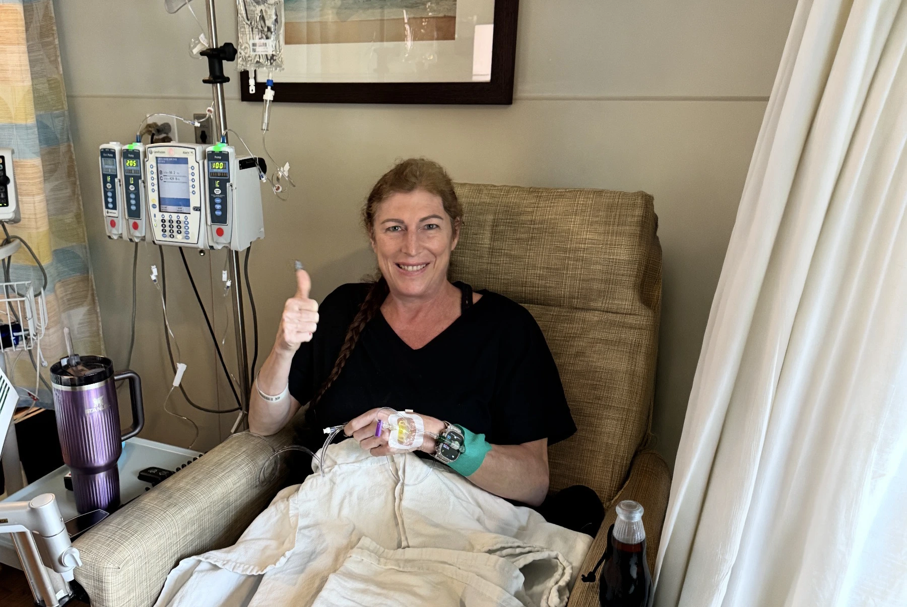 Angela Keim smiles while receiving chemo at Sylvester Comprehensive Cancer Center.