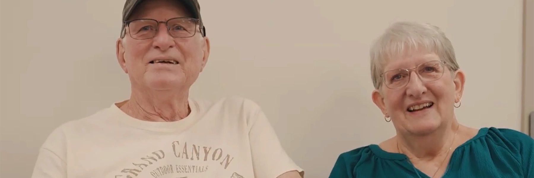 Melanoma survivor and wife sitting in Sylvester Comprehensive Cancer Center smiling after speaking with specialist