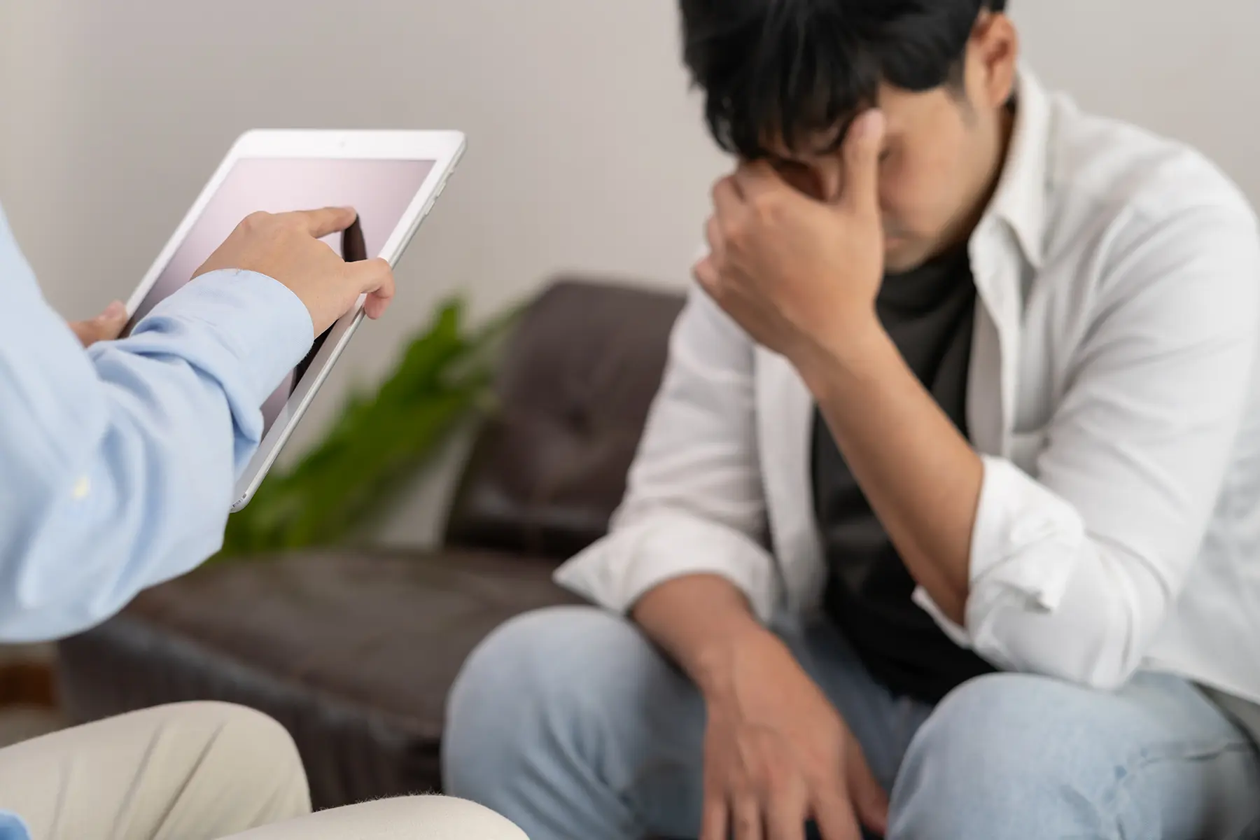 Man consulting a doctor about neurological and cerebral diseases, Parkinson's disease, dyskinesia