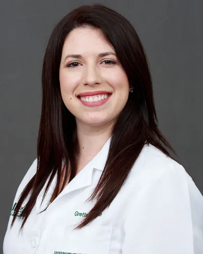 Dr. Grettel Garcia-Ruiz smiling for a portrait, wearing a white medical coat