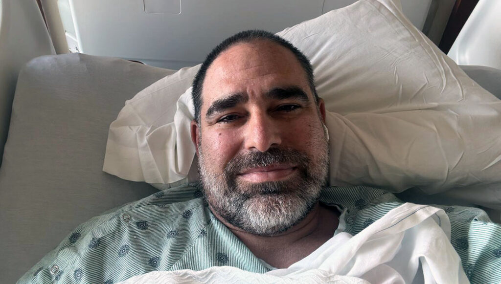 Red Gonzalez resting in a hospital bed during treatment for an aortic condition.