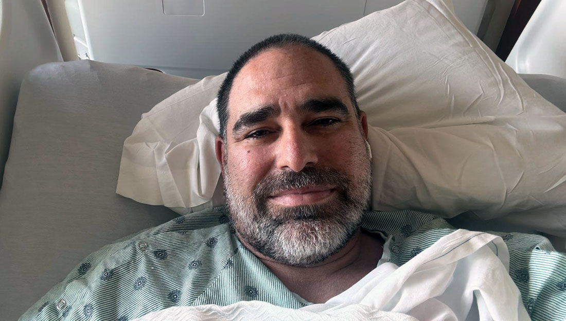 Red Gonzalez resting in a hospital bed during treatment for an aortic condition.